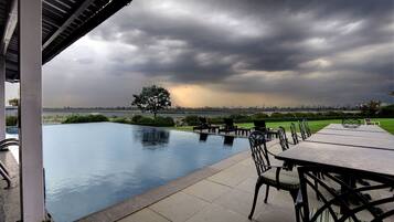 Outdoor pool, pool loungers, lifeguards on site