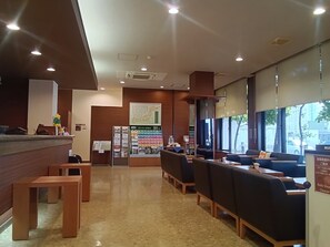 A restaurant interior with a reception desk, seating area, and a large window. - Hotel Route Inn Myoko Arai (Myoko)