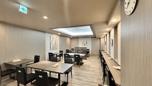 A modern conference room with a skylight, long tables, and chairs. - Hotel Route Inn Nagaoka Ekimae (Nagaoka)