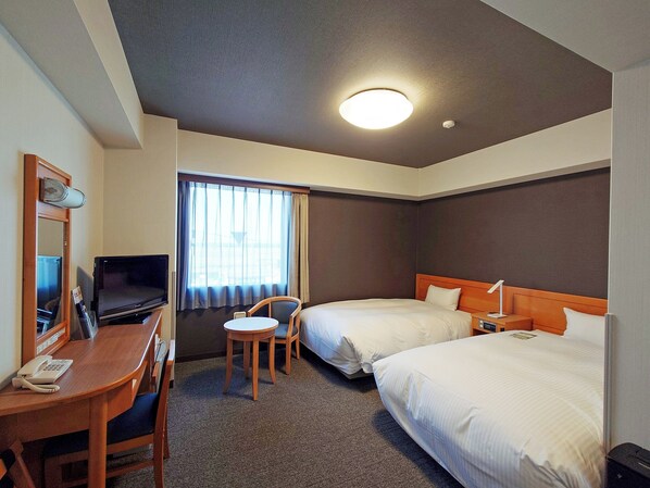 A hotel room with a desk, two beds, a TV, a chair, and a window with curtains. - Hotel Route Inn Shibata Inter (Shibata)