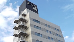 A multi-story building with a prominent sign at the top.