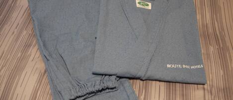 A folded grey shirt with a logo and text indicating it is from Route Inn Hotels.