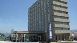A multi-story hotel with a flat facade, numerous windows, and a sign indicating it is a hotel. - Hotel Route Inn Ina Inter (Minamiminowa)