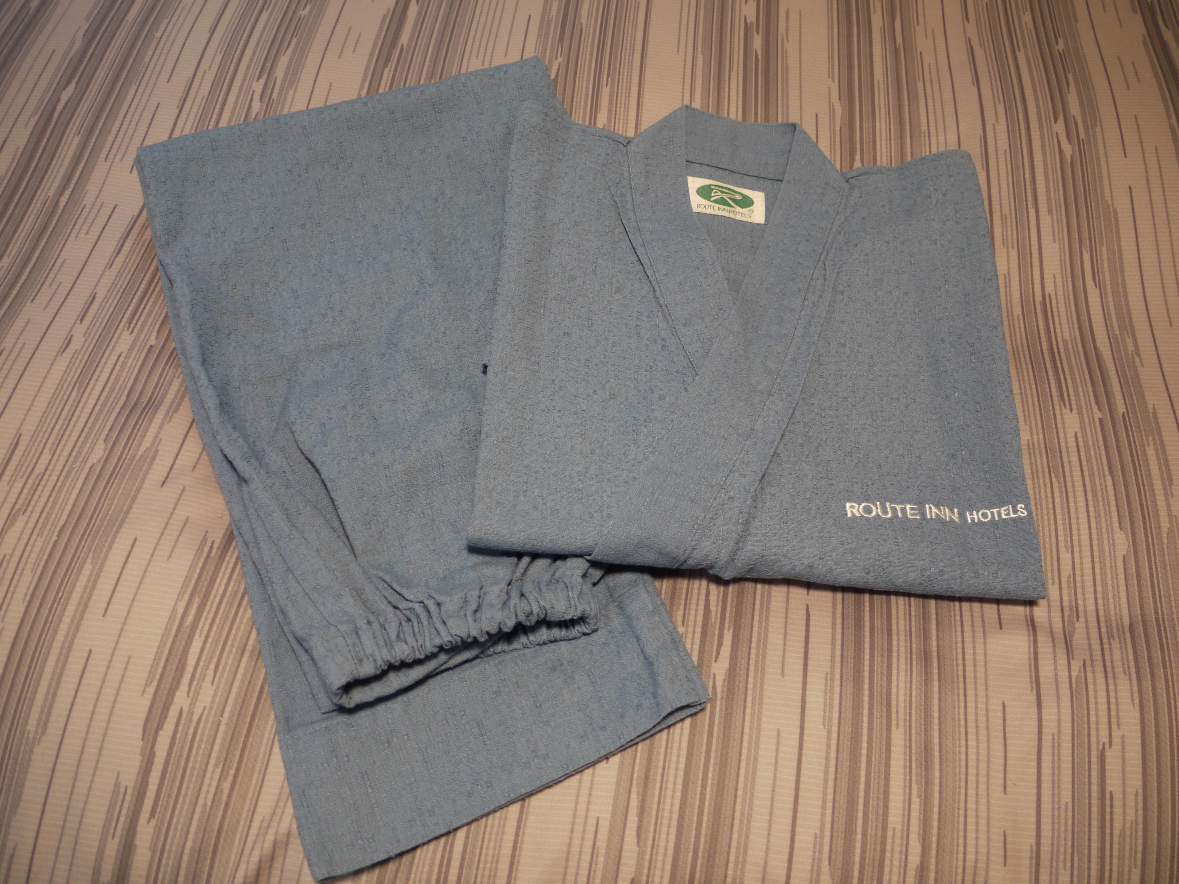 A folded grey shirt with a logo and text indicating it is from Route Inn Hotels.