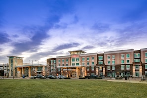 Experience the Hilton Garden Inn's modern design, set amidst a serene grassy area.