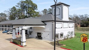 A white building with a covered entrance and a tower, labeled "1913" and "Super 8". - Super 8 by Wyndham Mansfield LA (Mansfield)