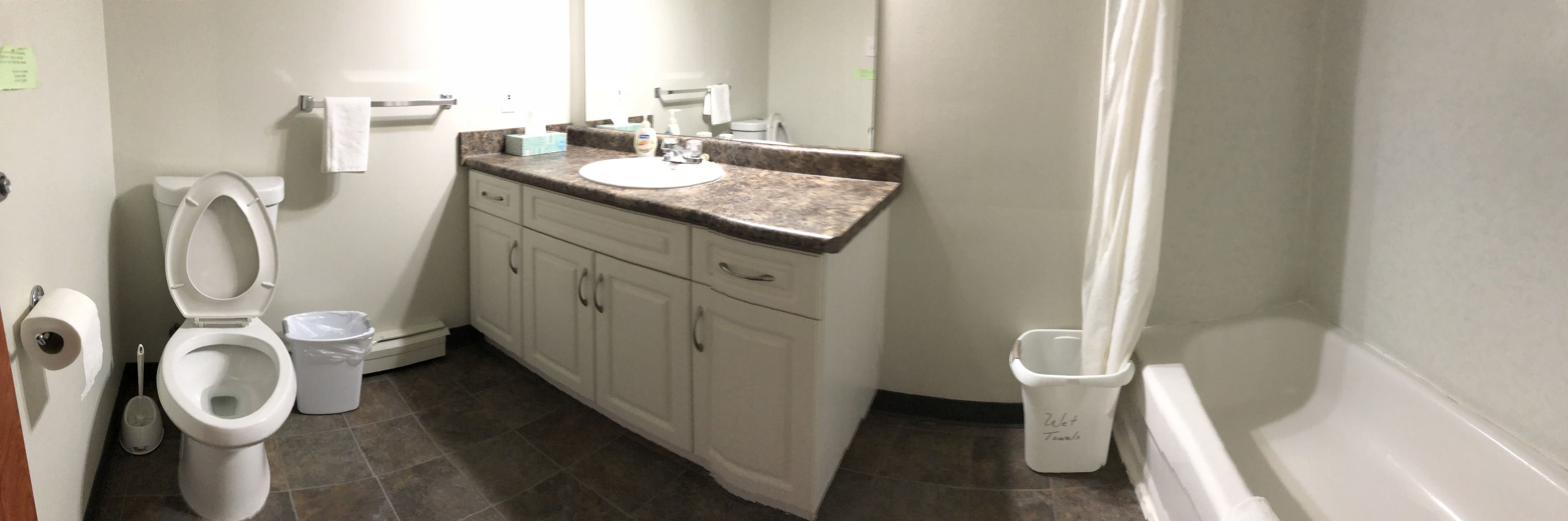A bathroom with a toilet, sink, and bathtub.