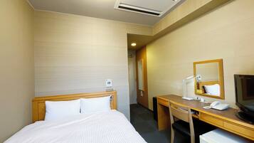 A hotel room with a bed, a desk, a chair, a television, a mirror, and a small refrigerator.