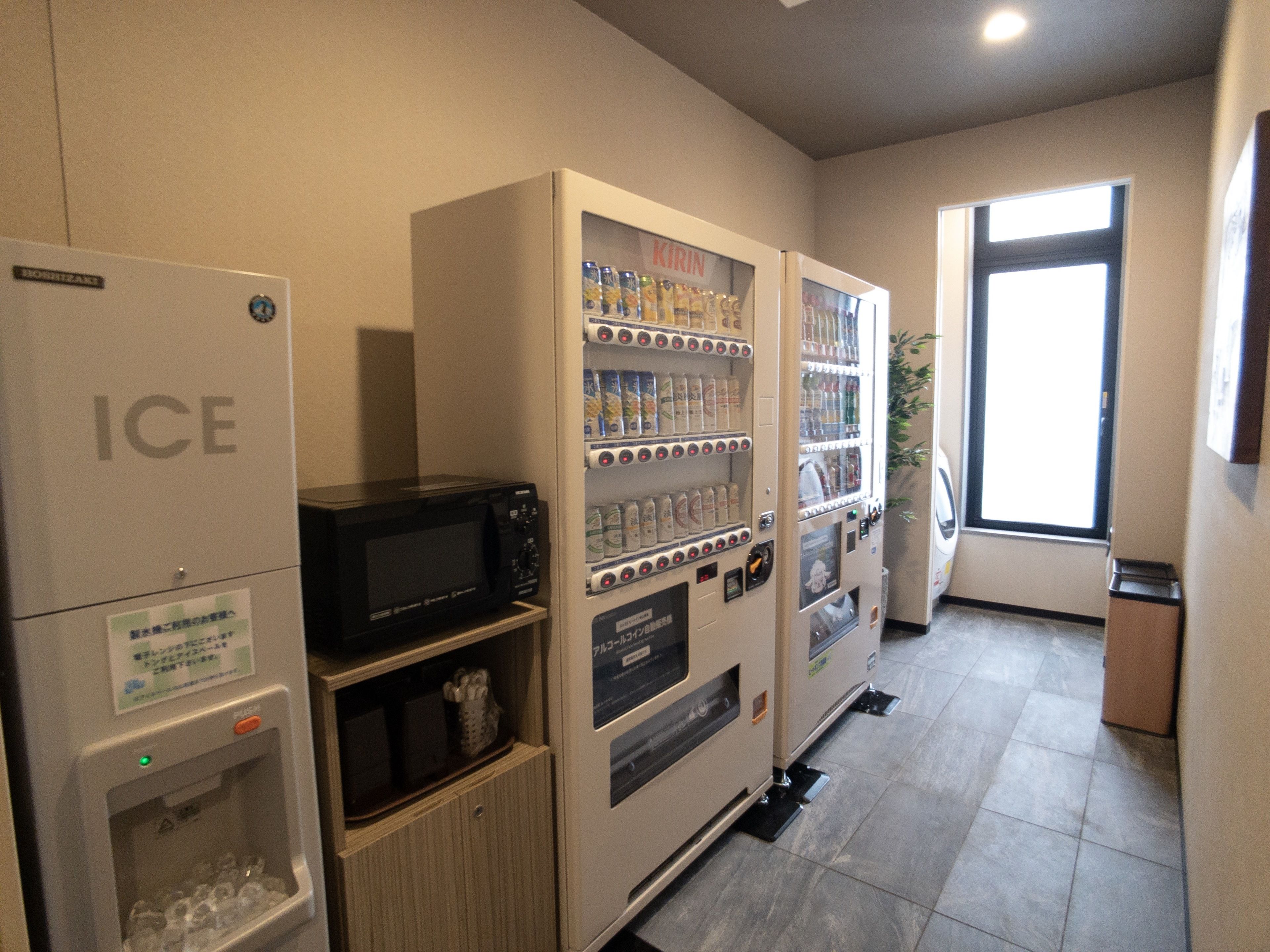 A vending area with an ice dispenser, a microwave, and beverage vending machines.