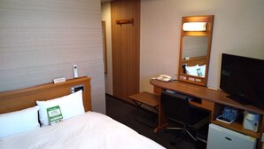 A hotel room with a bed, a desk with a telephone, a television, and a small refrigerator. - Hotel Route-Inn Odate Omachi (Odate)