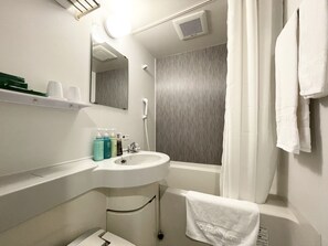 A bathroom with a sink, mirror, shower, and towel rack.