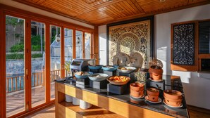 A breakfast buffet with various dishes and a view of the outdoors. - Karon Phunaka Resort (Karon)