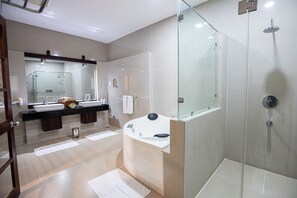 Enjoy a relaxing soak in the large bathtub or refreshing shower, with a spacious vanity and ample natural light.