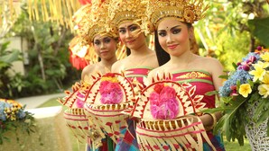 A group of individuals in traditional attire with elaborate headdresses and floral accessories. - Mahagiri Villas Sanur (Denpasar)