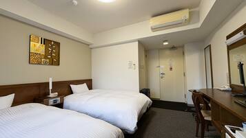 A hotel room with two beds, a desk, a chair, an air conditioning unit, and a door leading to another room.
