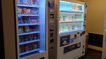 Two vending machines with various snacks and drinks.