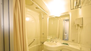 A bathroom with a bathtub, a sink, a toilet, and a mirror.