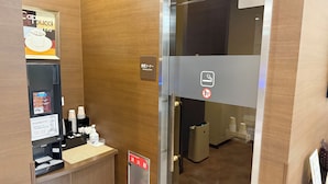A coffee machine, a smoking area sign, and a fire extinguisher sign in a hotel room. - Hotel Route-Inn Ichinoseki Inter (Ichinoseki)