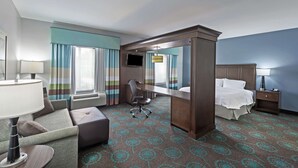 A hotel room with a bed, a desk, a chair, a TV, and a large mirror. - Hampton Inn & Suites Shreveport/Bossier City Airline Drive (Bossier City)