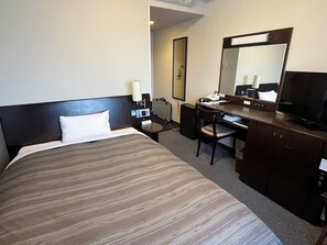 A hotel room with a bed, desk, chair, television, and a mirror. - Hotel Route-Inn Natori (Natori)