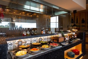 A buffet with various food items and condiments. - The Oasis Mussoorie - a member of Radisson Individuals (Dehradun)