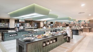 A modern buffet setup with multiple serving stations, a variety of food items, and a clean, contemporary design. - Hotel Riu Paraiso Lanzarote - All Inclusive (Tías)
