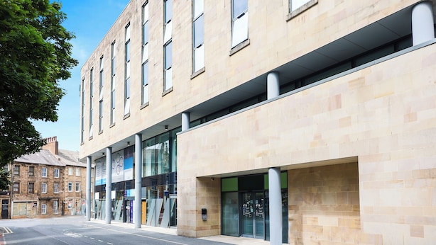 A modern building with large windows and a clean facade.
