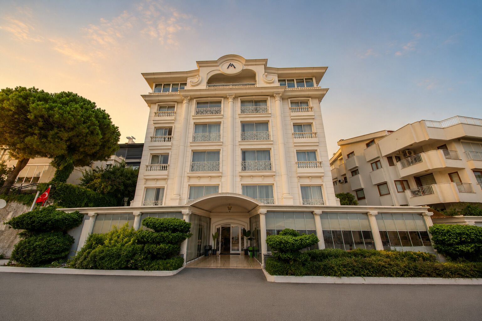 A multi-story hotel with a symmetrical facade, large windows, and a central entrance.