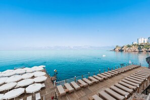 A seaside resort with a wooden deck, sun loungers, and umbrellas. - Massimo Hotel - Adults Only 'Ex La Boutique Hotels (Antalya)