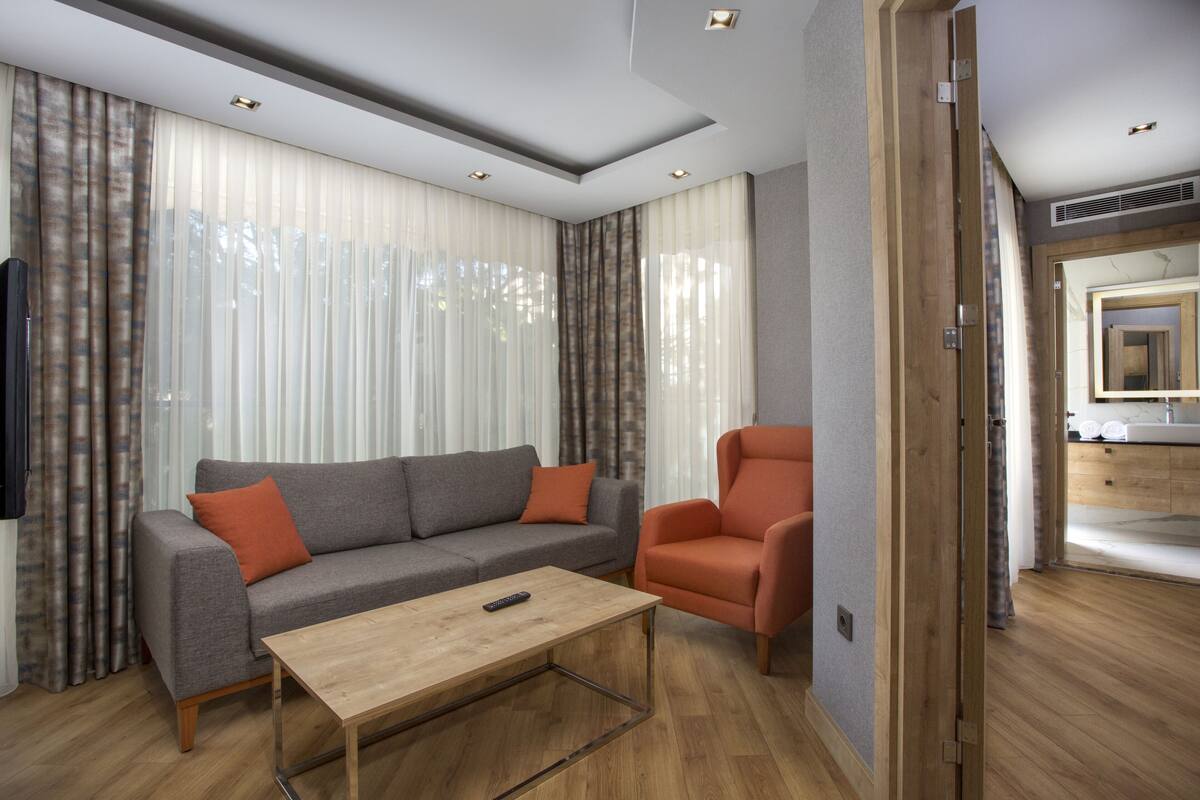 A modern living room with a sofa, armchair, and coffee table.