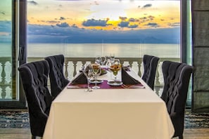 A dining table set for two with a view of the sea and sunset. - Massimo Hotel - Adults Only 'Ex La Boutique Hotels (Antalya)