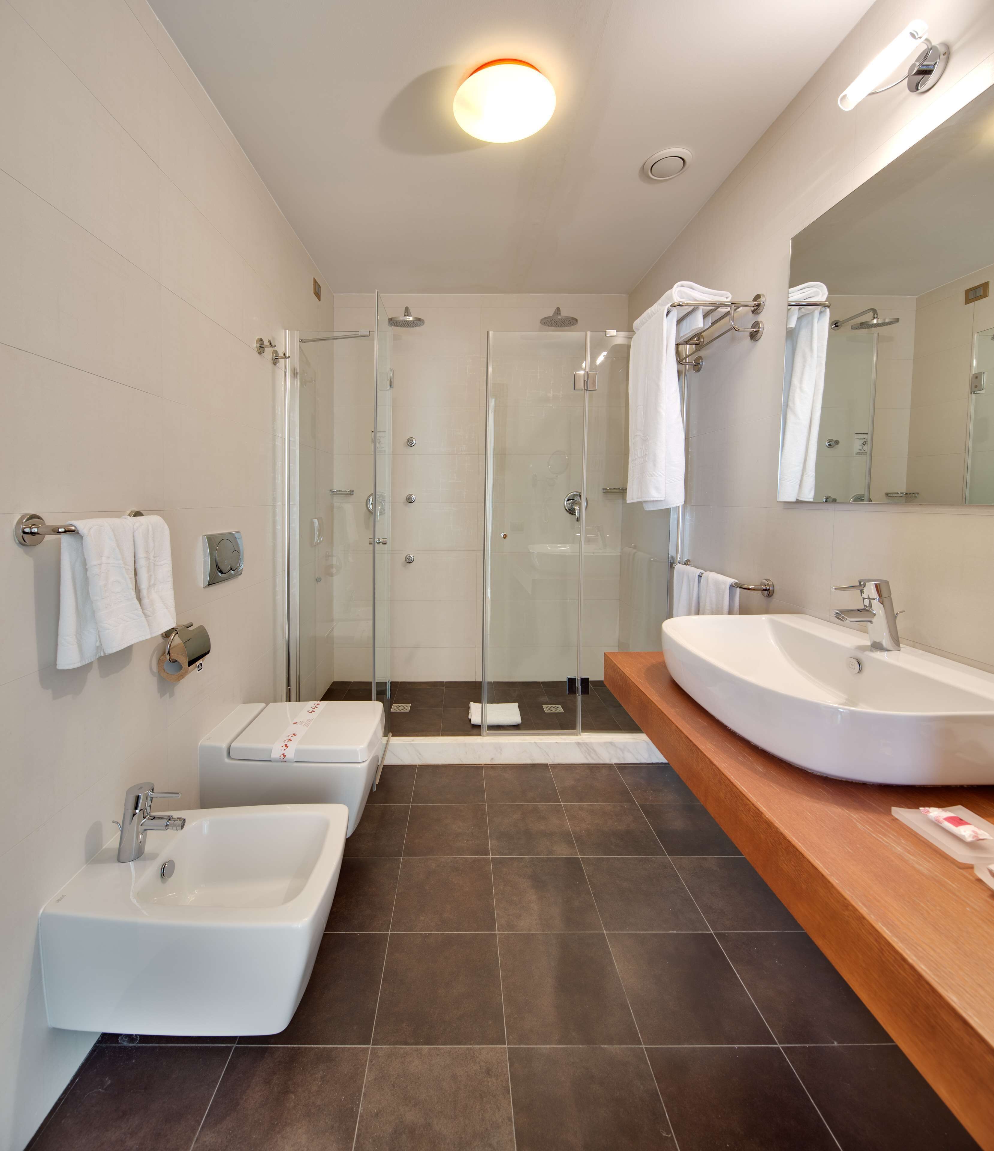 comfort room, multiple beds | bathroom | rainfall showerhead, free toiletries, hair dryer, bidet