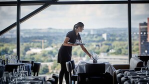 Een restaurant met uitzicht op een stadsbeeld door grote ramen.
