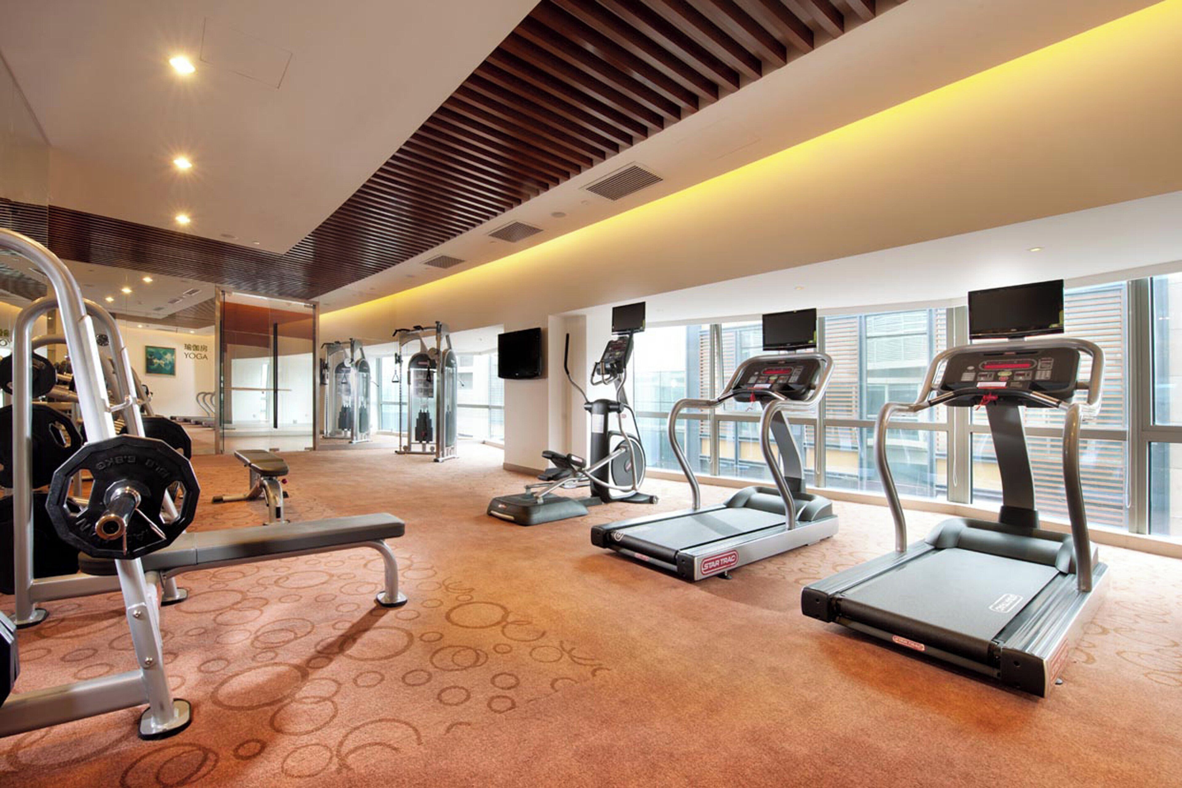 A gym with treadmills, weight machines, and cardio equipment.