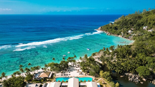 A resort with a pool, beach, and ocean view. - Kempinski Seychelles Resort (Mahé Island)