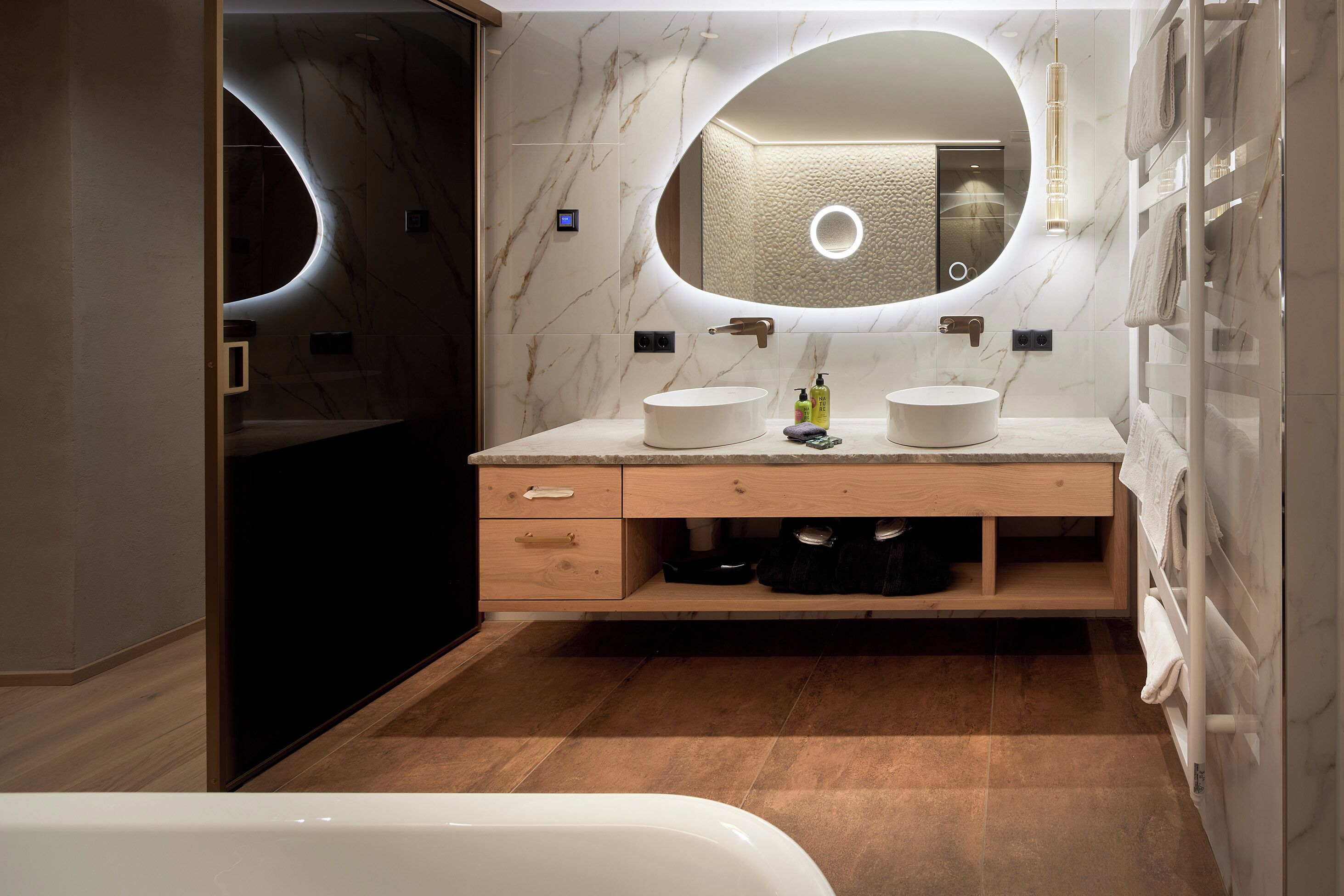 Une salle de bain moderne avec un meuble-lavabo à deux vasques, un grand miroir et une baignoire.