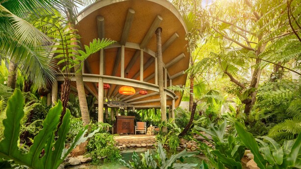 A circular wooden structure with a sign reading "Jungle Spa" surrounded by lush tropical vegetation and a small pond. - An Lam Retreats Saigon River (Ho Chi Minh City)