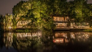 A riverside building with a wooden exterior and a covered patio area. - An Lam Retreats Saigon River (Ho Chi Minh City)