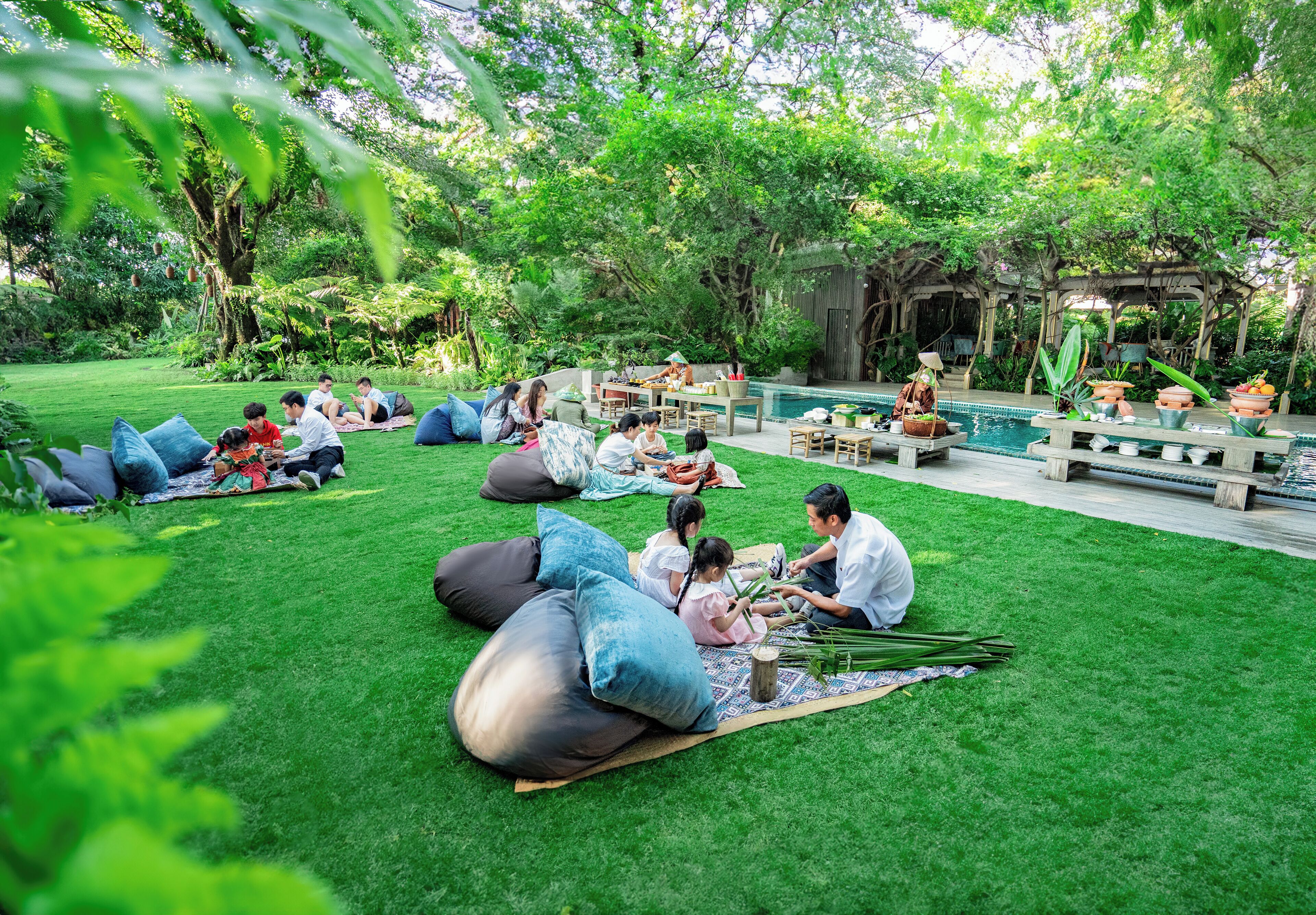 A lush garden with a pool, seating areas, and a gazebo.
