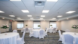 A conference room with round tables, white chairs, and floral centerpieces. - Holiday Inn Express & Suites Las Cruces North by IHG (Las Cruces)