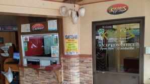 A reception office with a sign indicating it's open from 8am to 12 midnight. - Kokomos Hotel & Restaurant (Angeles City)