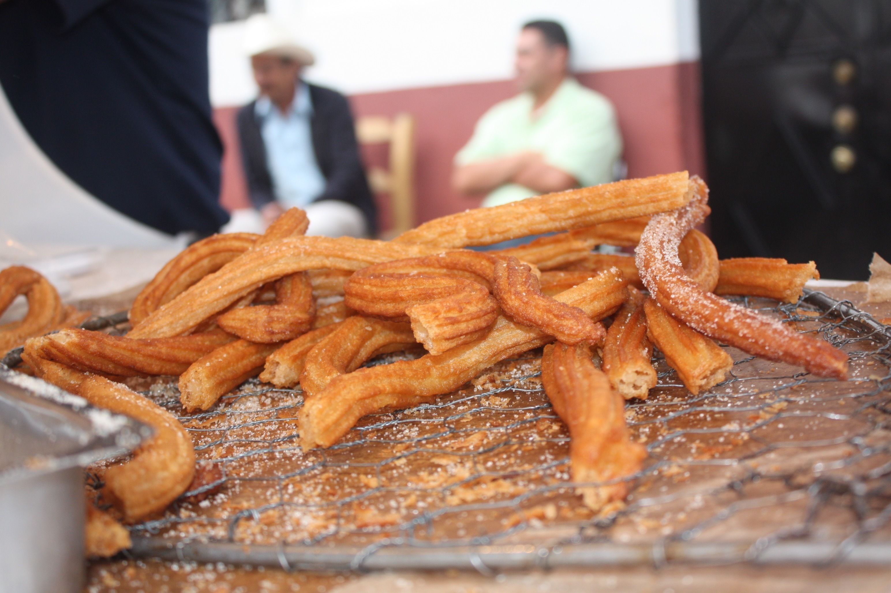 Churros on a wire rack.