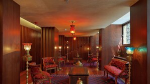 A traditional interior with wooden paneling, ornate furniture, and patterned rugs. - Burckin Hotel (Istanbul)