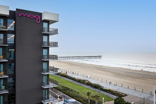 A modern hotel with a balcony and a view of the beach and pier. - Moxy Virginia Beach Oceanfront (Virginia Beach)