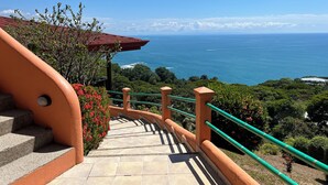 A staircase leading to a scenic overlook with a view of the ocean.