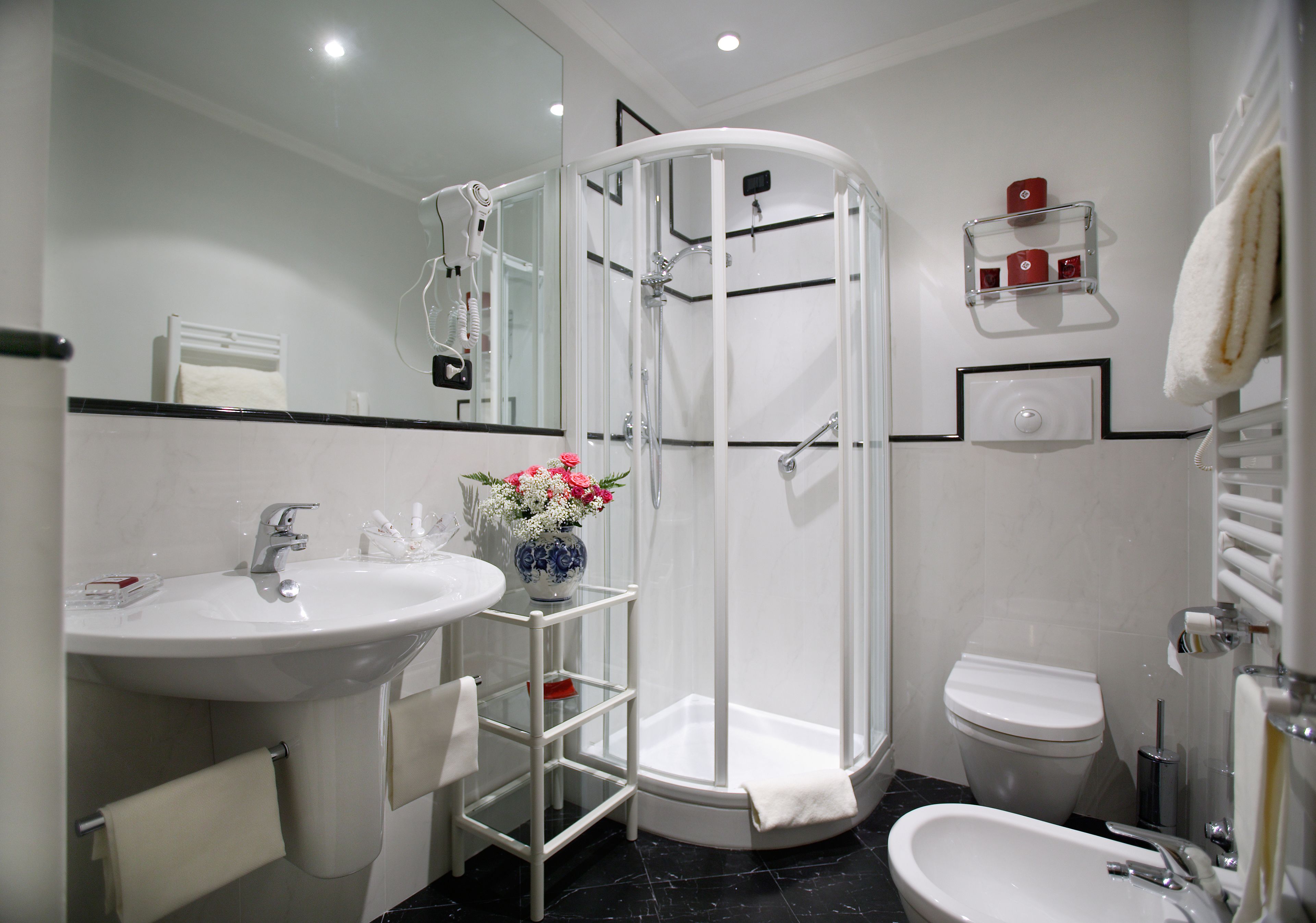 designer toiletries, hair dryer, slippers, bidet