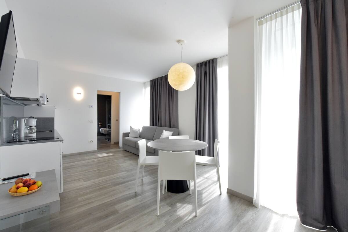 premium apartment, 1 queen bed with sofa bed, mountain view | living area | 22-inch tv with satellite channels