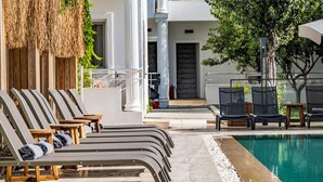 A poolside area with lounge chairs and a swimming pool. - Costa Maya Hotel (Bodrum)