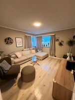 Family Apartment, 3 Bedrooms | Living area | Flat-screen TV, heated floors