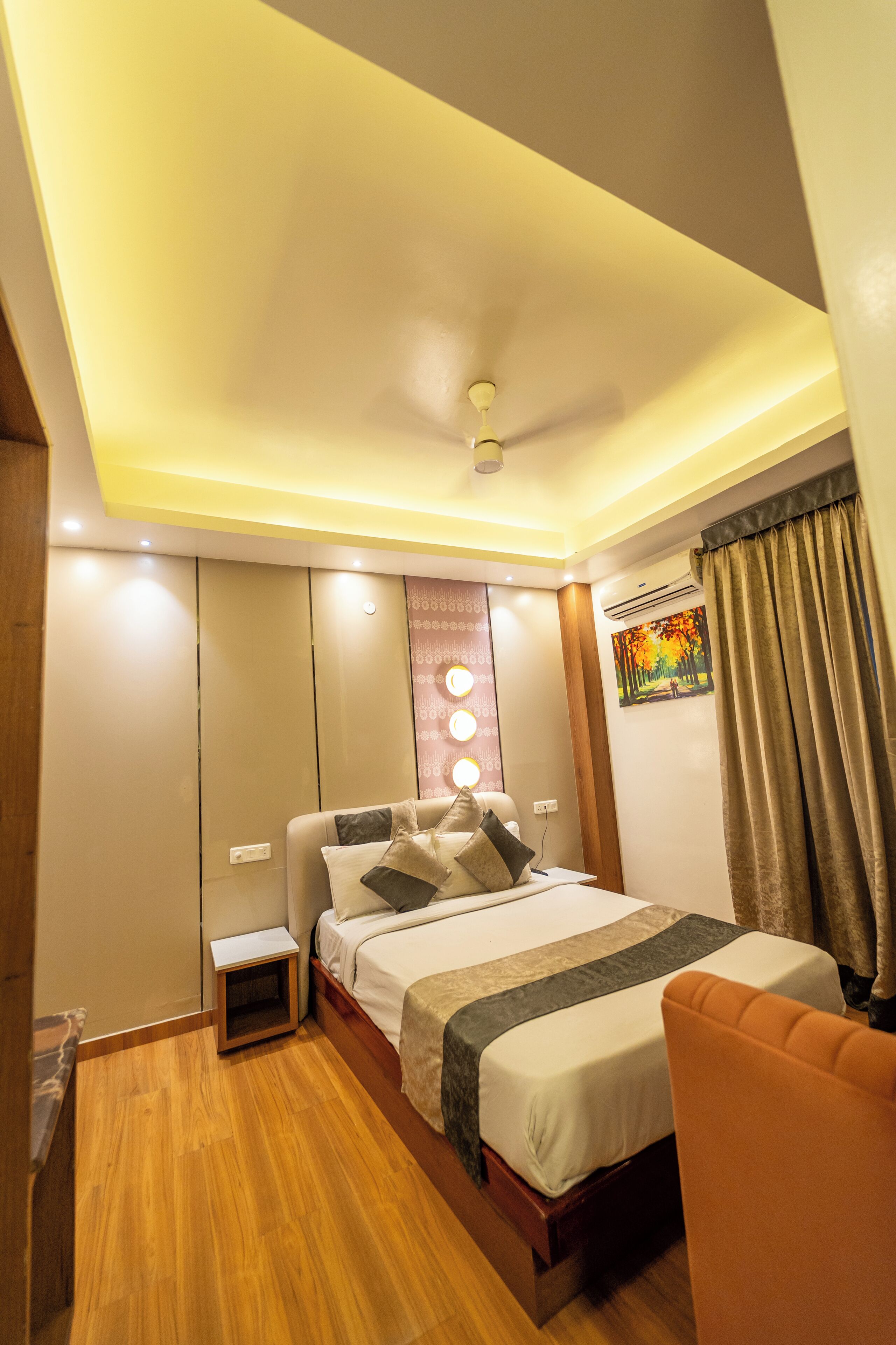 A bedroom with a bed, bedside table, and a chair.
